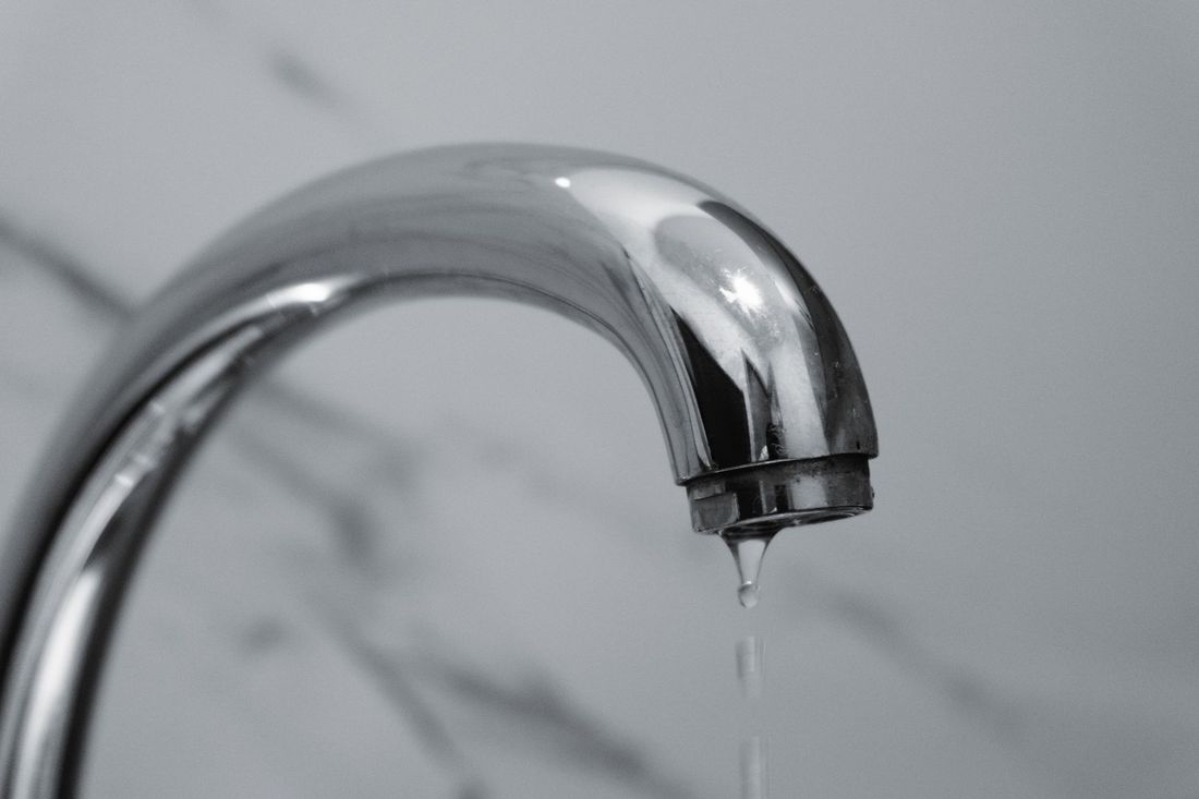 Water dripping from a chrome mixer tap